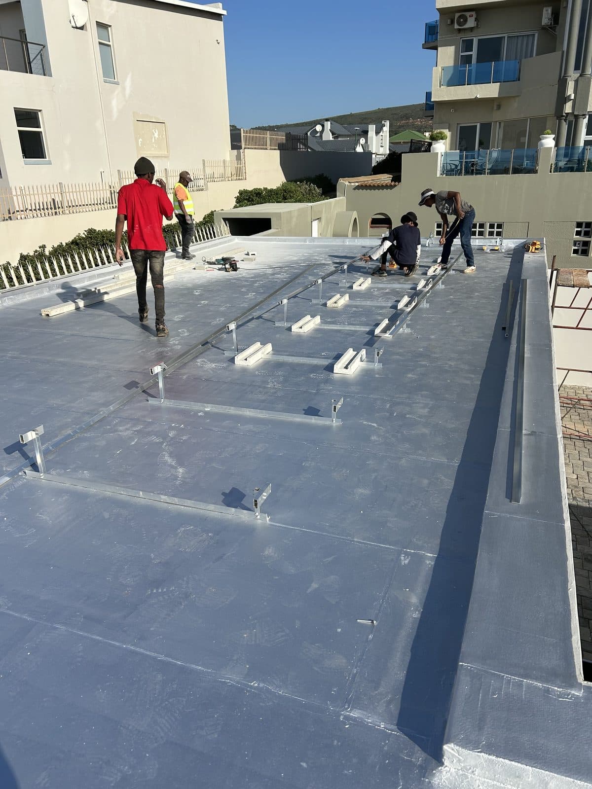 The Sky Projects team working on a rooftop solar installation in Mossel Bay